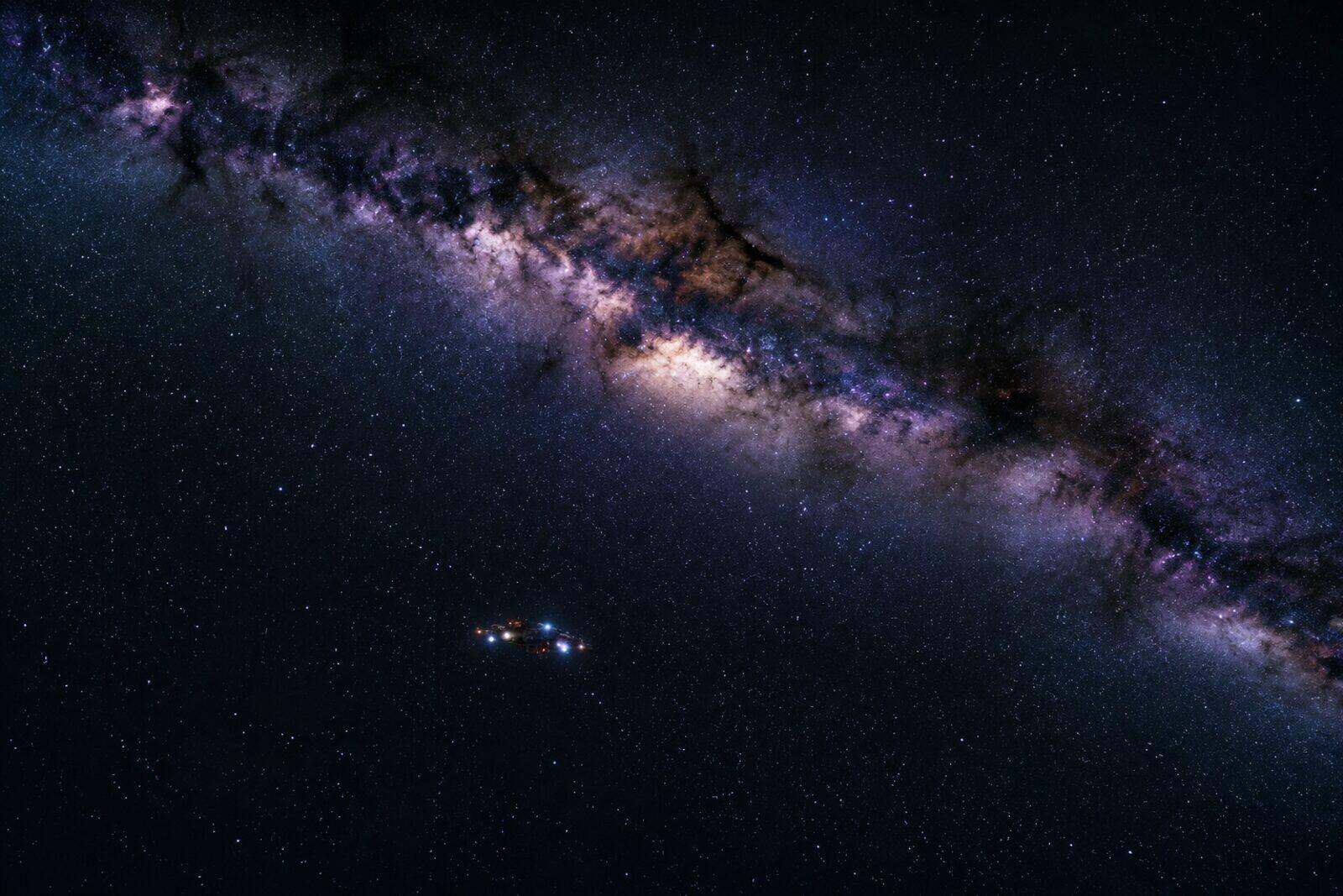 A single small ship silhouetted against the Milky Way with no planet in sight